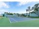 Well-maintained tennis court with lush green surroundings provides a recreational amenity for residents at 623 Garland Cir, Indian Rocks Beach, FL 33785