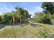 Spacious backyard with mature trees and partial fence offering privacy at 6427 15Th N St, St Petersburg, FL 33702