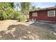 Spacious backyard featuring a concrete patio area, surrounded by mature trees and landscaping at 6427 15Th N St, St Petersburg, FL 33702