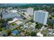 Aerial view shows commercial properties and neighborhood homes in a sunny, coastal community at 6750 Hibiscus S Ave, South Pasadena, FL 33707