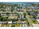 Aerial view shows residential properties with mature trees in a sunny, coastal community at 6750 Hibiscus S Ave, South Pasadena, FL 33707