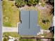 Aerial view of a home featuring a well-maintained roof, a driveway, and a manicured lawn at 6750 Hibiscus S Ave, South Pasadena, FL 33707