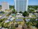 Aerial view of neighborhood properties near high rise buildings and mature trees at 6750 Hibiscus S Ave, South Pasadena, FL 33707