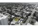 Aerial view highlights a charming yellow house nestled in a vibrant neighborhood setting at 6750 Hibiscus S Ave, South Pasadena, FL 33707