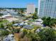Aerial view shows the neighborhood properties near high rise buildings and mature trees at 6750 Hibiscus S Ave, South Pasadena, FL 33707
