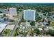 Overhead shot shows neighborhood homes near high rise buildings and established trees at 6750 Hibiscus S Ave, South Pasadena, FL 33707