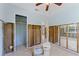 Bathroom with open doorway to another room and tile floors and toilet ready for installation at 6750 Hibiscus S Ave, South Pasadena, FL 33707