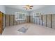 Bedroom featuring two windows for natural light and block and wood walls ready for renovation at 6750 Hibiscus S Ave, South Pasadena, FL 33707