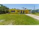 Charming yellow single-story home with blue shutters and a well-maintained front yard at 6750 Hibiscus S Ave, South Pasadena, FL 33707