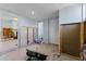 View from the kitchen area into another room featuring ceramic floors and tile walls at 6750 Hibiscus S Ave, South Pasadena, FL 33707