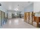 Open-concept layout featuring ceramic floors, a ceiling fan, and an exterior door at 6750 Hibiscus S Ave, South Pasadena, FL 33707