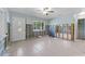 Spacious room featuring ceramic floors, a ceiling fan, and an exterior door at 6750 Hibiscus S Ave, South Pasadena, FL 33707