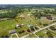 Stunning aerial perspective of a well-kept home surrounded by sprawling, fenced acreage with lush greenery at 7627 Artifact Dr, Zephyrhills, FL 33541