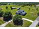 Aerial shot showcasing a beautiful home with a sprawling lawn, mature trees, and a long driveway at 7627 Artifact Dr, Zephyrhills, FL 33541