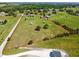 Aerial view of the property, showcasing the home, outbuildings, and extensive grounds at 7627 Artifact Dr, Zephyrhills, FL 33541