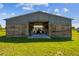 Exterior of the barn, featuring metal siding and a large open doorway for easy access at 7627 Artifact Dr, Zephyrhills, FL 33541