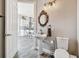 Powder room featuring a pedestal sink with decorative mirror, and stylish fixtures at 7627 Artifact Dr, Zephyrhills, FL 33541