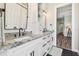 Bright bathroom featuring a double vanity with stunning countertops and modern fixtures at 7627 Artifact Dr, Zephyrhills, FL 33541