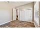 This bedroom features stylish wood-look tile flooring, and a spacious closet at 7627 Artifact Dr, Zephyrhills, FL 33541