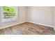 Bright and airy bedroom with hardwood floors and a large window offering plenty of natural light at 7627 Artifact Dr, Zephyrhills, FL 33541
