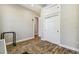 Cozy bedroom features sliding closet doors, wood-look tile flooring, and neutral color palette at 7627 Artifact Dr, Zephyrhills, FL 33541