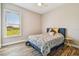 This bedroom offers natural light and wood-look tile flooring at 7627 Artifact Dr, Zephyrhills, FL 33541