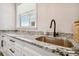 Bathroom with granite countertops, undermount sink, and modern fixtures at 7627 Artifact Dr, Zephyrhills, FL 33541
