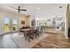 Open-concept dining with adjacent kitchen, ceiling fan and easy access to outdoor living at 7627 Artifact Dr, Zephyrhills, FL 33541