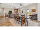 Open dining area with farm table, views and seamless flow to living room at 7627 Artifact Dr, Zephyrhills, FL 33541