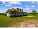 Beautiful single-Gathering home featuring a wrap-around porch and a lush green lawn at 7627 Artifact Dr, Zephyrhills, FL 33541