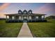 Charming single-story home featuring a welcoming front porch and well-maintained landscaping at 7627 Artifact Dr, Zephyrhills, FL 33541