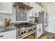 Well-equipped kitchen featuring stainless steel appliances, granite countertops, and decorative backsplash at 7627 Artifact Dr, Zephyrhills, FL 33541