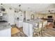 Open kitchen layout with granite counters, island and access to the living area at 7627 Artifact Dr, Zephyrhills, FL 33541