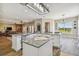 Open-concept kitchen with granite countertops, stainless steel appliances, and a kitchen island at 7627 Artifact Dr, Zephyrhills, FL 33541