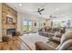 Cozy living room features fireplace, french doors, and ceiling fan, offering a welcoming space at 7627 Artifact Dr, Zephyrhills, FL 33541