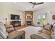 Inviting living room with a brick fireplace, ceiling fan, and comfortable seating at 7627 Artifact Dr, Zephyrhills, FL 33541