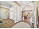 Spacious and bright living space featuring beautiful wood floors, arched doorways, and comfortable seating at 7627 Artifact Dr, Zephyrhills, FL 33541