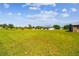 Wide shot of the expansive property featuring a home, outbuildings, and large open fields at 7627 Artifact Dr, Zephyrhills, FL 33541