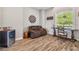 Cozy sitting area with wood floors, comfortable seating, and a stylish wine refrigerator at 7627 Artifact Dr, Zephyrhills, FL 33541