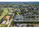 Wide aerial view of neighborhood homes, trees, golf course, and ponds at 8064 Brentwood Rd, Seminole, FL 33777