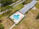Aerial view of community pool surrounded by chairs and clubhouse for residents and their guests at 8064 Brentwood Rd, Seminole, FL 33777