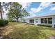 Well-manicured backyard with lush green lawn and mature trees at 8064 Brentwood Rd, Seminole, FL 33777