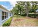 Property showing large backyard with lawn and mature tree landscaping at 8064 Brentwood Rd, Seminole, FL 33777