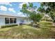 Backyard featuring lush green lawn and beautiful mature trees at 8064 Brentwood Rd, Seminole, FL 33777