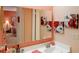 Bright bathroom with a large vanity mirror and a glimpse into an adjoining bedroom at 8064 Brentwood Rd, Seminole, FL 33777