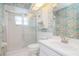 Bathroom featuring a walk-in shower, toilet, and sink with colorful floral wallpaper at 8064 Brentwood Rd, Seminole, FL 33777
