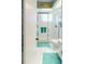 Bathroom featuring a glass-enclosed shower, tile flooring, and patterned wallpaper at 8064 Brentwood Rd, Seminole, FL 33777