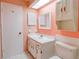 Bathroom features a white vanity, sink, and medicine cabinet at 8064 Brentwood Rd, Seminole, FL 33777