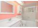 Bathroom featuring white vanity, framed mirror, toilet, and shower with sliding glass doors at 8064 Brentwood Rd, Seminole, FL 33777