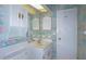 Bathroom featuring colorful wallpaper, a white vanity, a decorative mirror, and a toilet at 8064 Brentwood Rd, Seminole, FL 33777